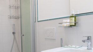 A bathroom with a shower, toilet, and sink. - Vesuvio Blu Apartment in the center of Naples (Napoli)