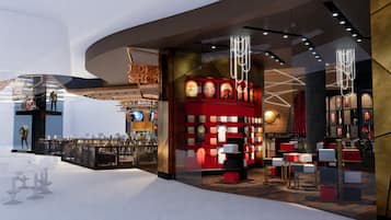Un interior moderno con una zona de bar, asientos y una sección temática en rojo.