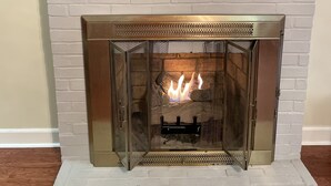 A fireplace with a TV mounted above it.