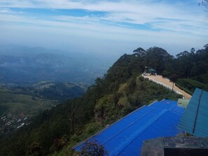 Surrounded by lush greenery, this mountain retreat offers breathtaking views of the valley below.