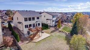 Un barrio residencial con casas, una terraza de madera y cielo despejado.