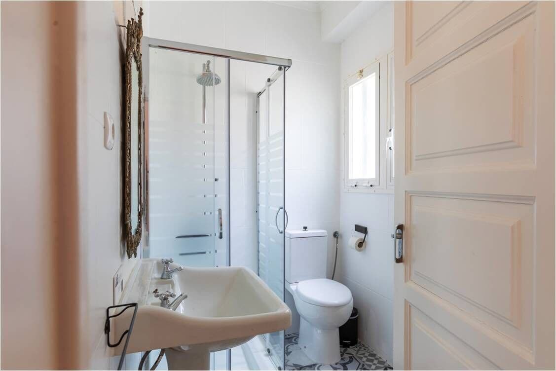 A bathroom with a sink, toilet, and shower.