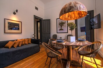 Living room with wooden lamp in the dining table and sofa bed