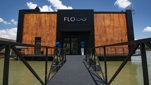 A building with a wooden facade and a black entrance. - Flow (Belgrade)