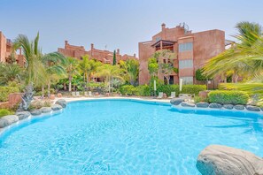 A swimming pool surrounded by palm trees and a building with a flat roof. - Bahia - Romen 2.2 PENTHOUSE SEA VIEW & JACUZZI 2B (Arona)