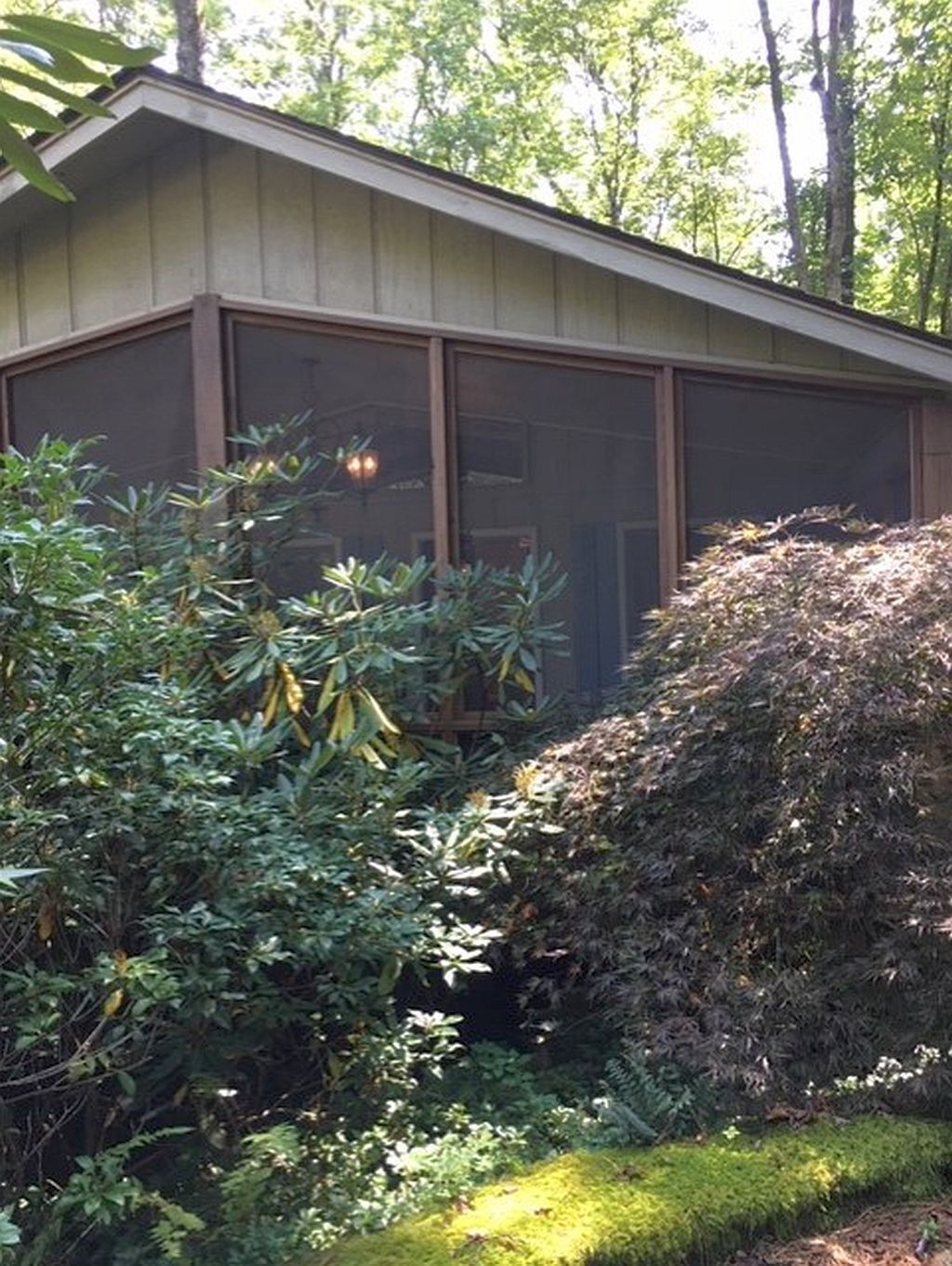 A house with a large window and a covered porch.