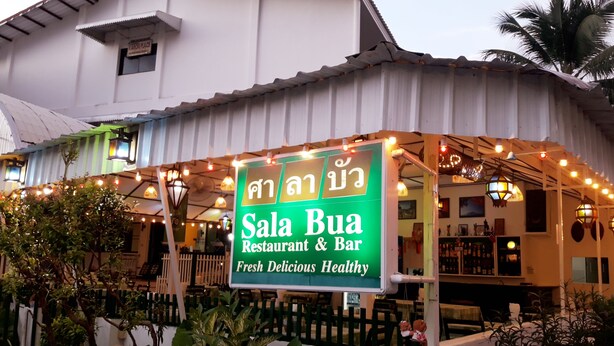 A restaurant named Sala Bua with a signboard, outdoor seating, and a white building facade. - Sala Bua Room Karon (Karon)