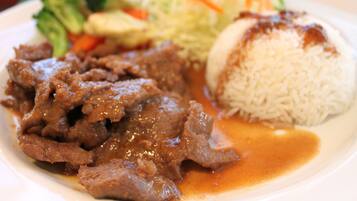 A plate with beef, rice, and vegetables.