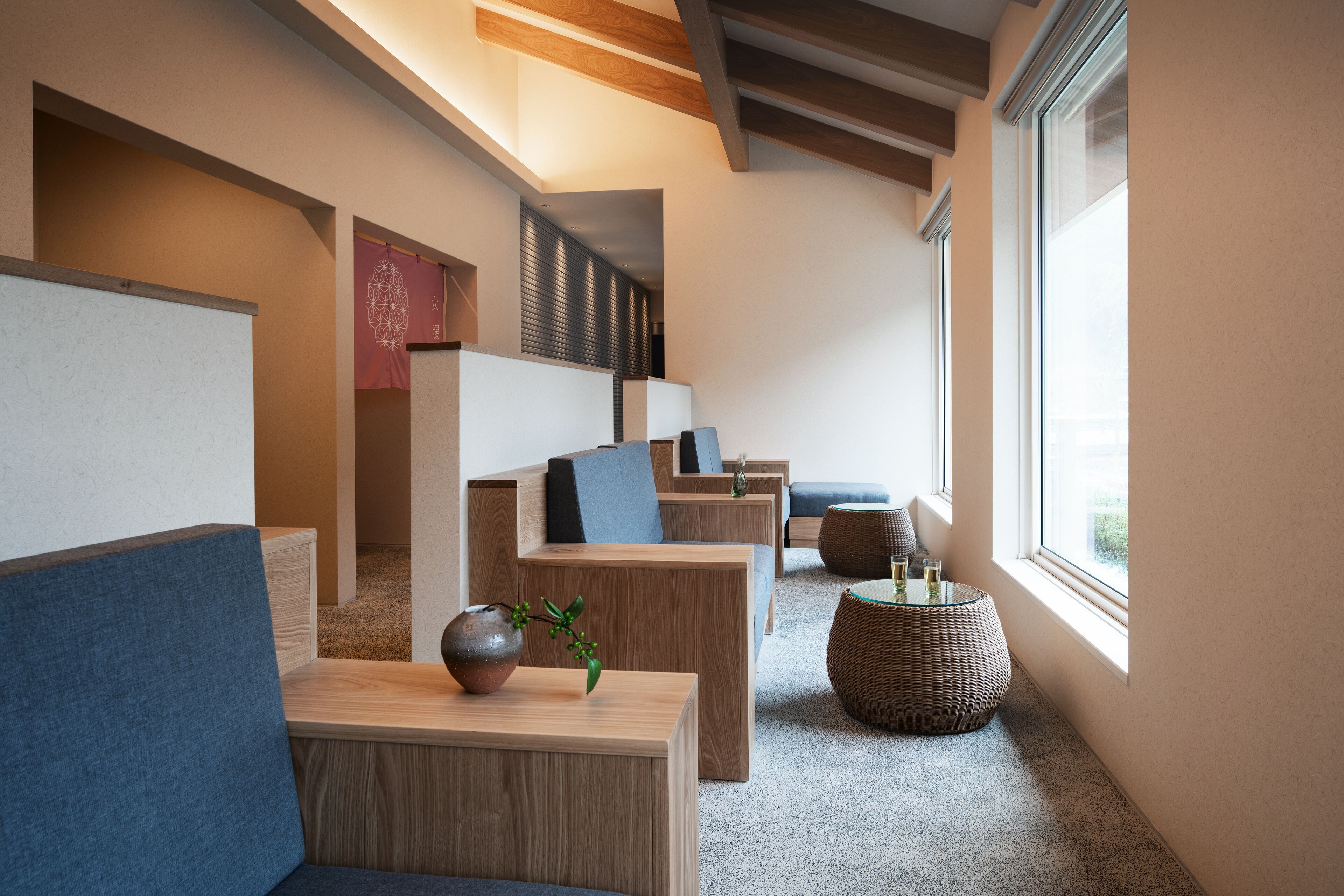 A modern interior with wooden furniture, a large window, and a decorative vase.