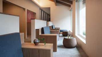 A modern interior with wooden furniture, a large window, and a decorative vase.