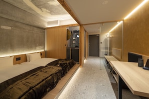 A modern hotel room with a large bed, a desk, and a mirror. - Kyoto ITOYA Hotel Mon (Kyoto)