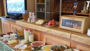 A buffet setup with various food items and a sign labeled "BREAD". - Hotel Asia Mountains 2 (Bishkek)
