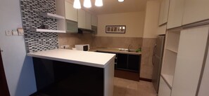 Family Apartment, 2 Bedrooms | Private kitchenette | Fridge, microwave, electric kettle, freezer - Rihanna Service Suite at Times Square (Kuala Lumpur)