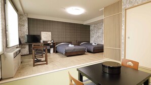 A hotel room with a bed, a desk with a television, a chair, and a table with a decorative item. - Hotel Granjam Tsugaike (Otari)