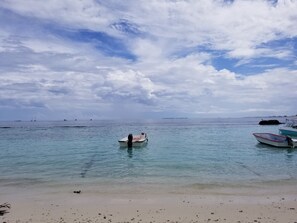 On the beach, white sand, beach towels, beach bar