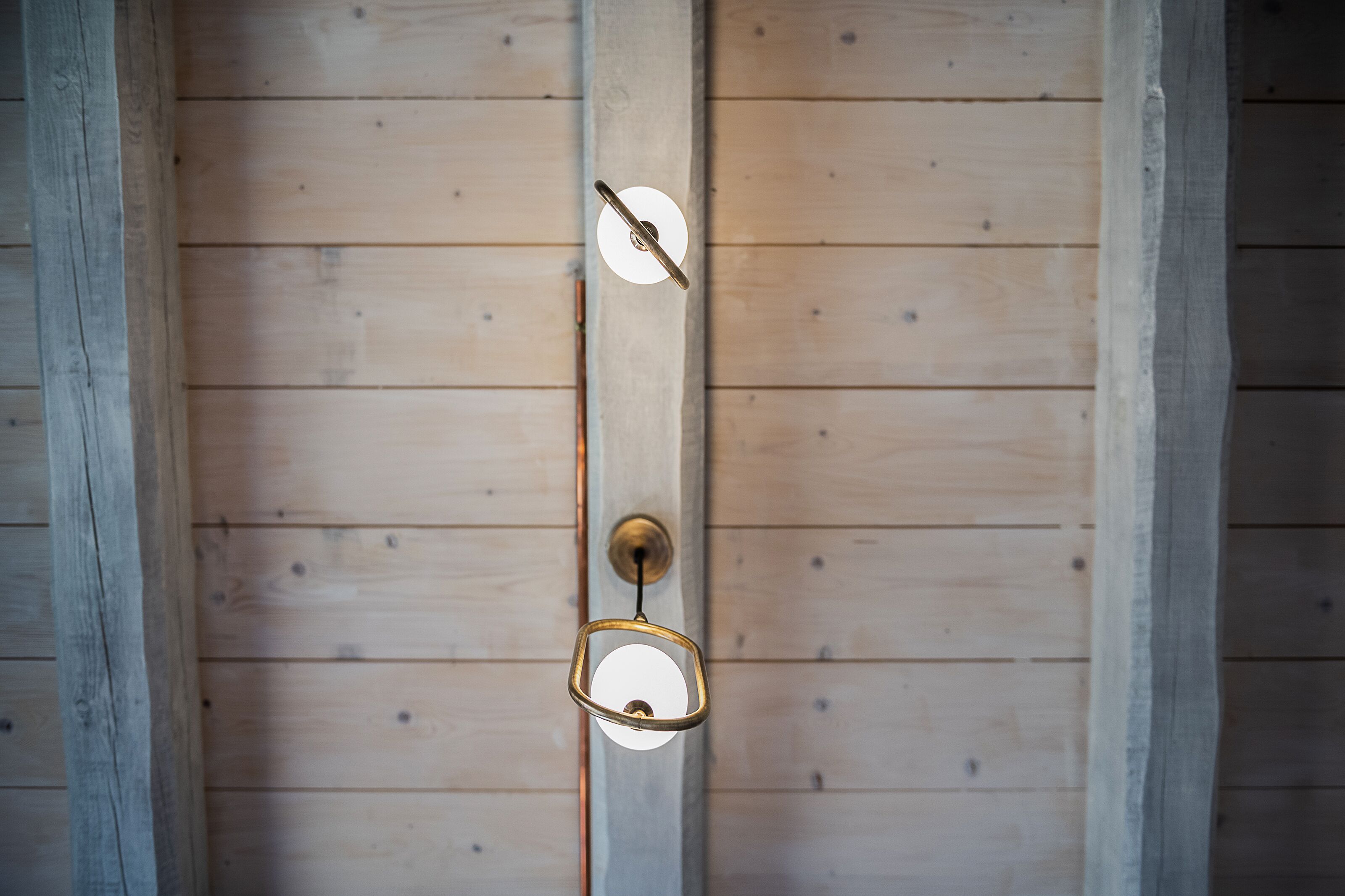 A wooden ceiling with a hanging light fixture.