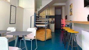 A modern interior with a staircase, seating area, and kitchen. - UNICO - Art & Decor (Ostuni)