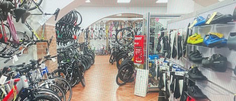 A bicycle shop with various bikes and accessories on display.