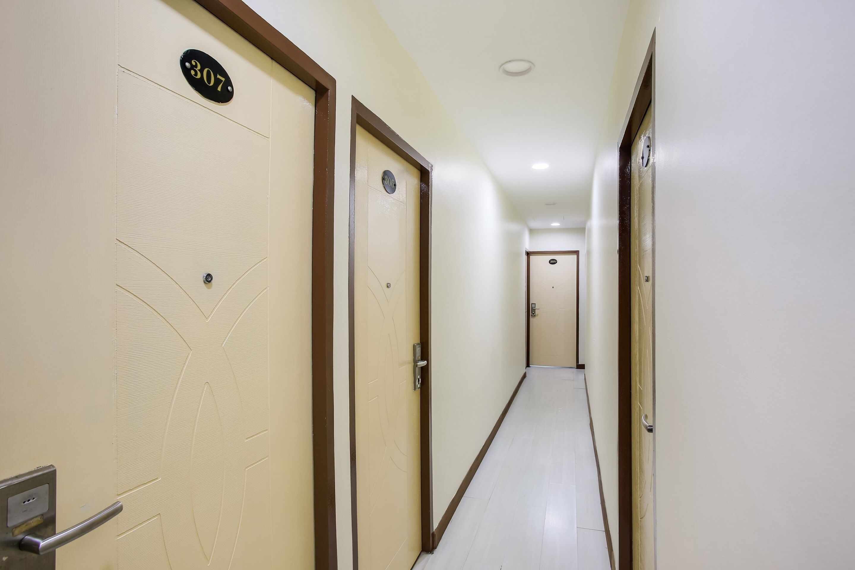 A hallway with doors numbered 307 and 308, leading to rooms.