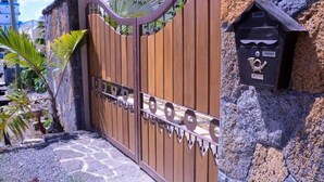 A gated entrance with a mailbox and a stone wall. - Modern and cozy apartment (Pereybere)