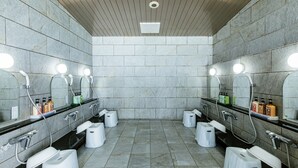 A modern bathroom with multiple sinks, mirrors, and toiletries.
