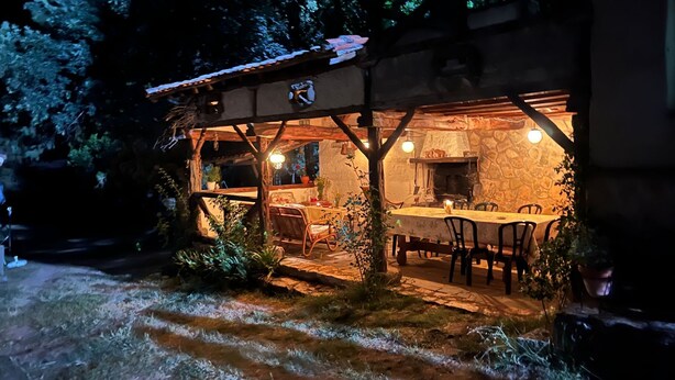 An outdoor dining area with a stone fireplace, wooden beams, and potted plants. - Finca La Cerquilla in Segovia (one hour from Madrid) (Ventosilla y Tejadilla)