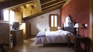 A bedroom with a wooden ceiling, a bed, a dresser, a television, and a radiator. - Finca La Cerquilla in Segovia (one hour from Madrid) (Ventosilla y Tejadilla)