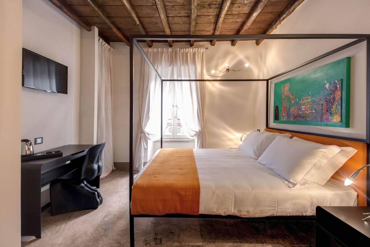 A modern bedroom with a bed, a desk, and a chair.