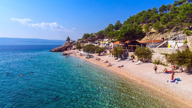 A coastal beach with clear waters, people swimming, and beachside buildings. - VILLA MASLINA, with private 32m2Pool, panoramic views on 100km coastline, 12 pax (Lokva Rogoznica)