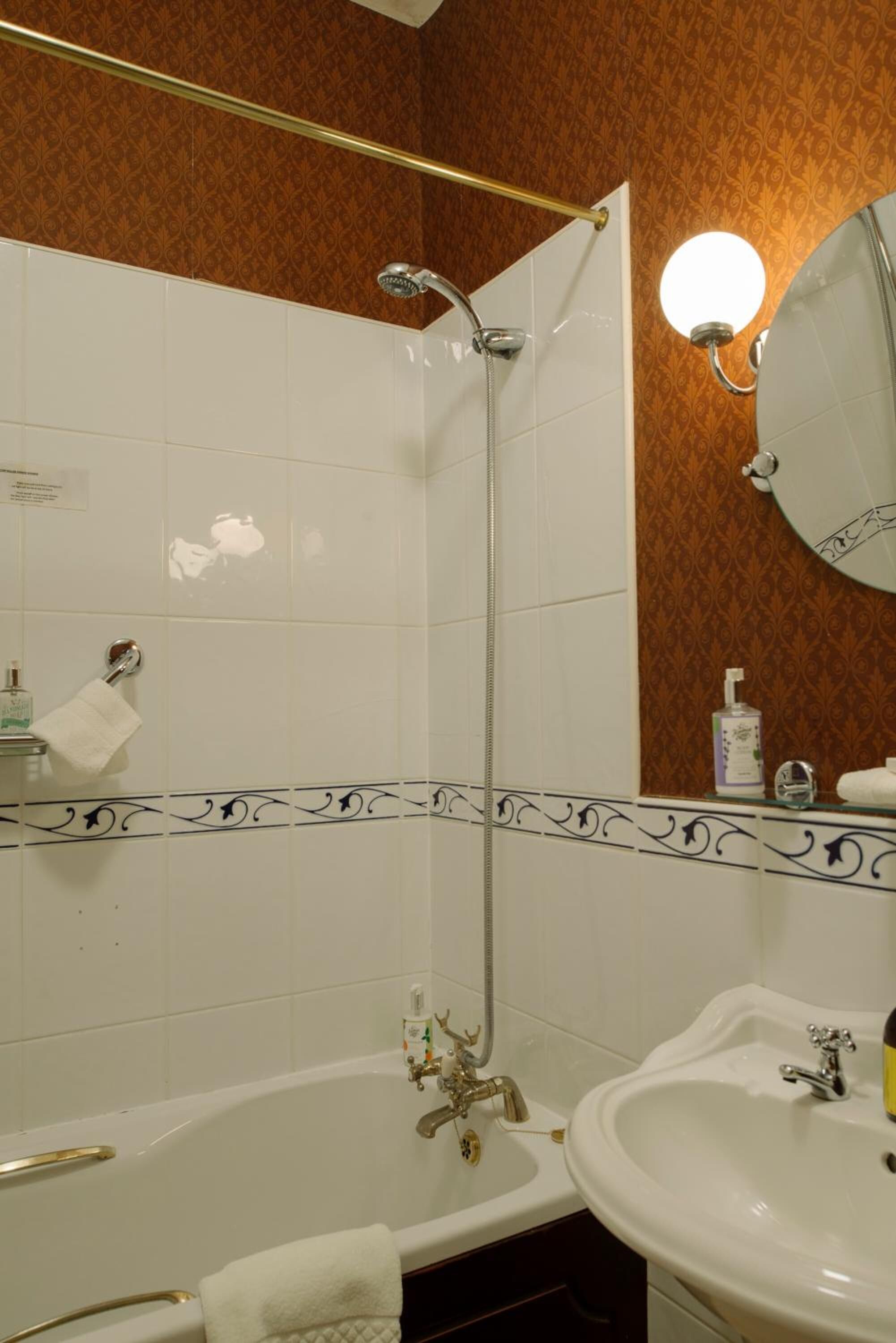 A bathroom with a bathtub, a sink, and a shower.