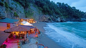 A coastal hotel with a beach view, a restaurant, and a tented area. - ** LAST MINUTE ** VILLA VITTORIA (sleeps 8), by Villas & Retreats: Pool, A/C, Wi-Fi, BBQ (Licciana Nardi (MS))