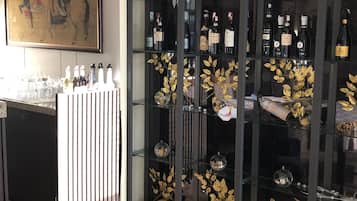A modern living room with a wine rack, a painting, and a sofa.