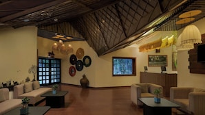 A spacious lobby with a high ceiling, a large window, and a reception desk. - The Fern Ranthambhore Forest Resort Sawai Madhopur, Series by Marriott (Sawai Madhopur)