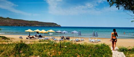 On the beach, sun-loungers, beach umbrellas, beach bar