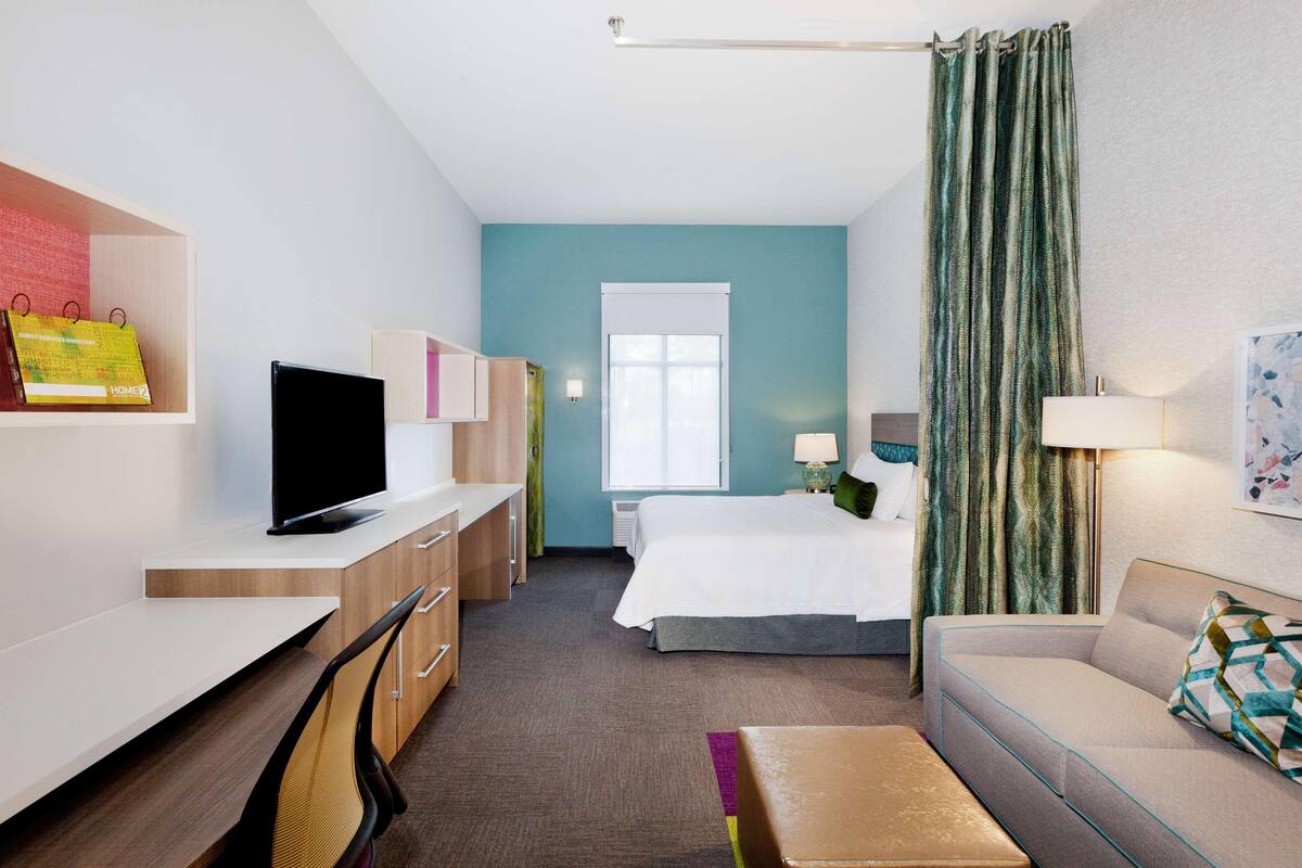 Premium bedding, desk, laptop workspace, blackout drapes