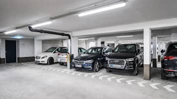 A multi-level underground parking garage with cars parked in designated spaces.