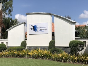 A building with a sign that reads "Seabreeze Residence."