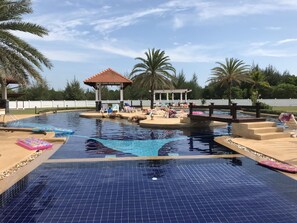 A swimming pool with lounge chairs and a gazebo. - Laem Mae Phim - Beachfront living in a villa with a private pool ! (Tambon Kram Amphur Klaeng)