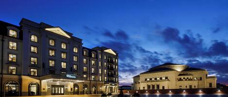 A large hotel with multiple floors and a spacious courtyard.