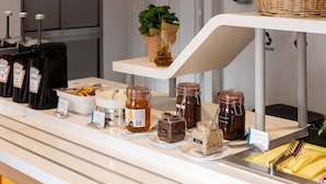 A buffet counter with various food items and condiments. - ibis budget Krakow Stare Miasto (Kraków)