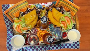 A tray with fried food, salad, and condiments on a patterned tablecloth. - Family Suite with 3 Bedrooms | Up to 6 Guests in Monferrato (Tagliolo Monferrato)