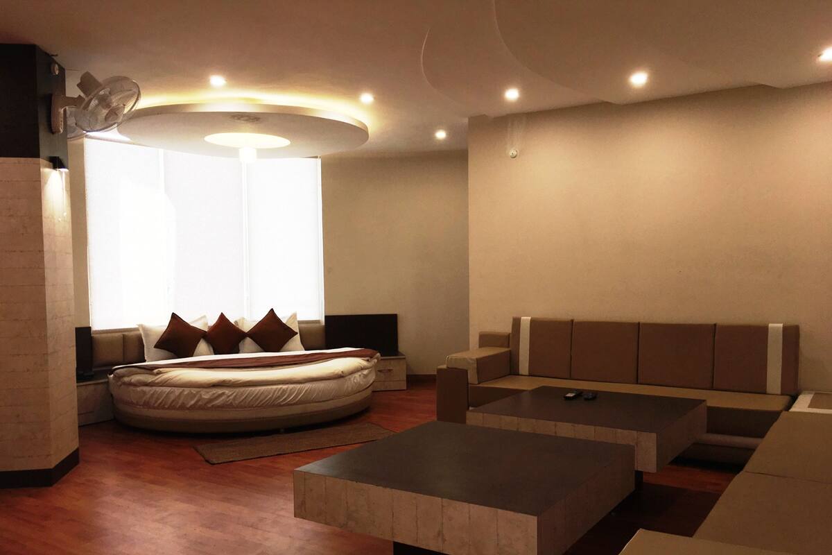 A modern living room with a sofa, a bed, and a coffee table.
