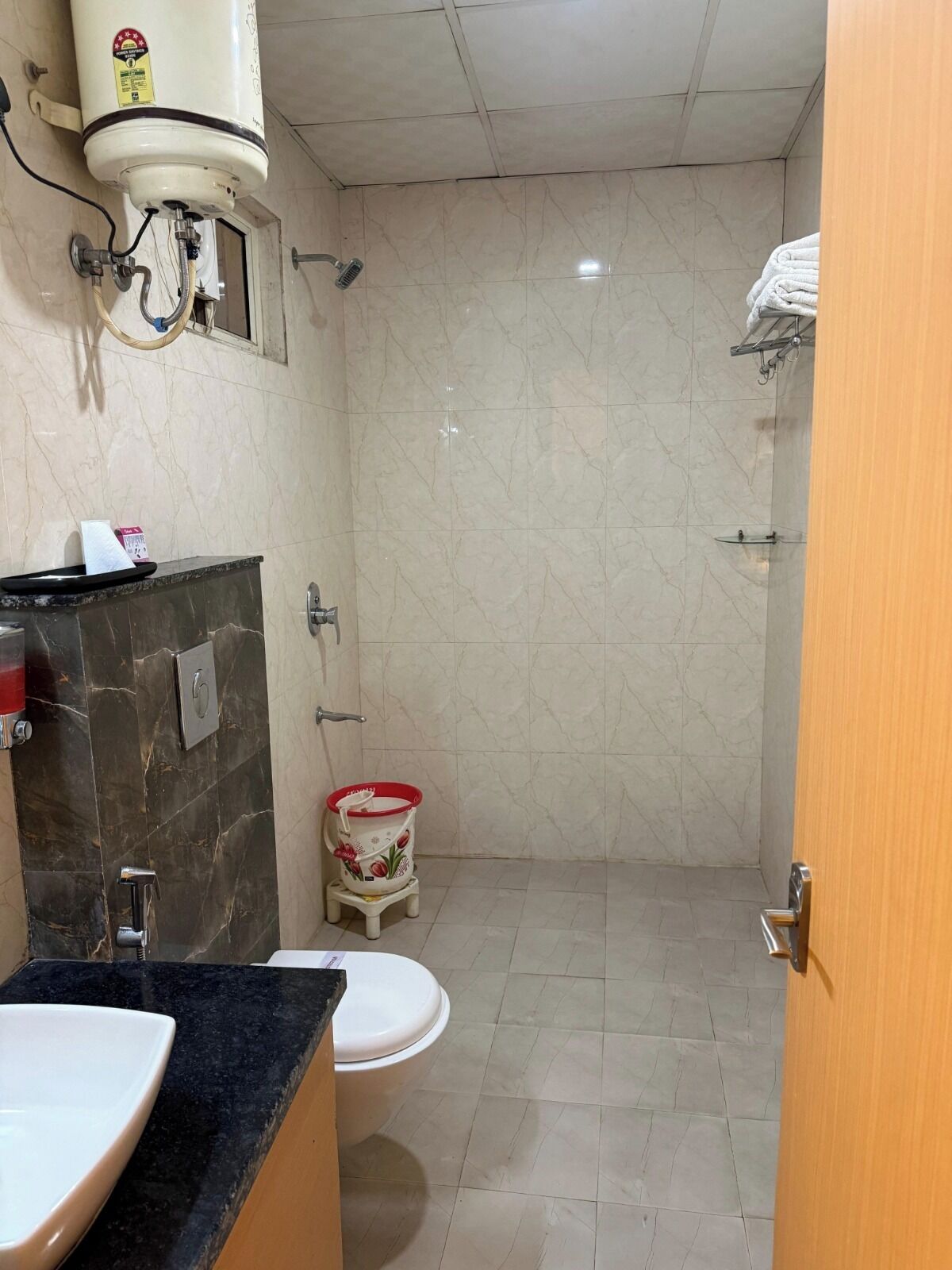 A bathroom with a toilet, sink, and shower.