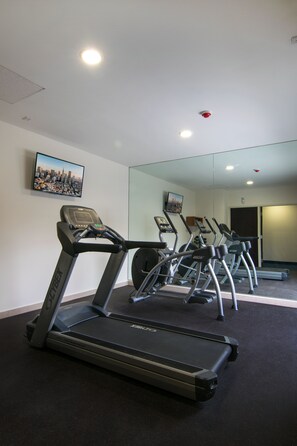 A gym with treadmills and a mirrored wall. - Sleep Inn Queretaro (Querétaro)