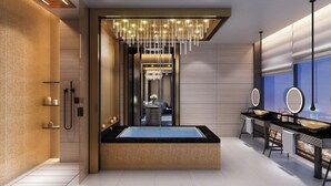 Ein modernes Badezimmer mit einer großzügigen Badewanne, einer Duschkabine und einem Waschtisch mit Spiegel.