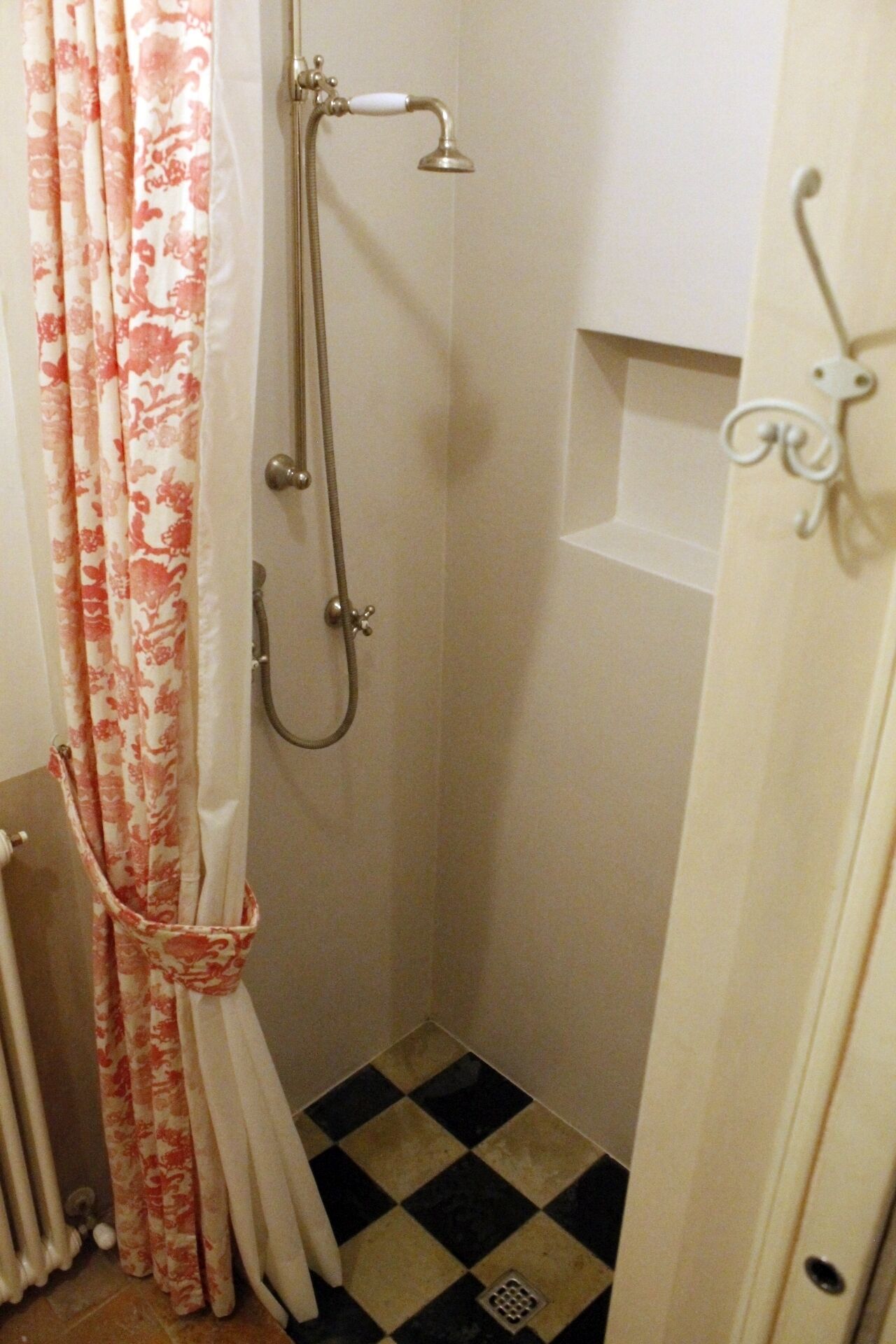 A small bathroom with a shower, a toilet, and a sink.