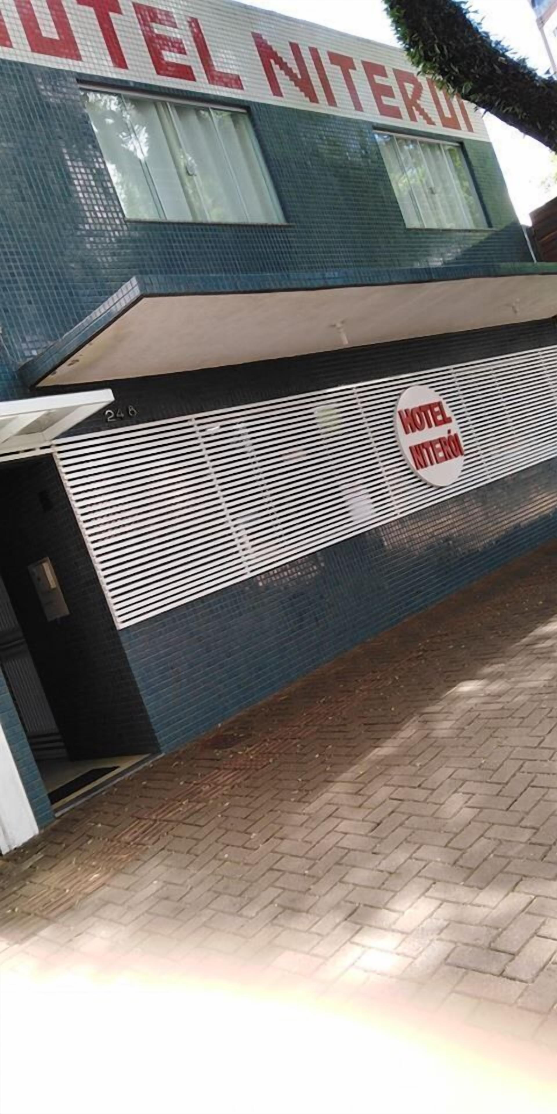 A hotel exterior with a prominent sign reading "HOTEL NITEROLI" and a smaller sign below stating "HOTEL NITEROLI".
