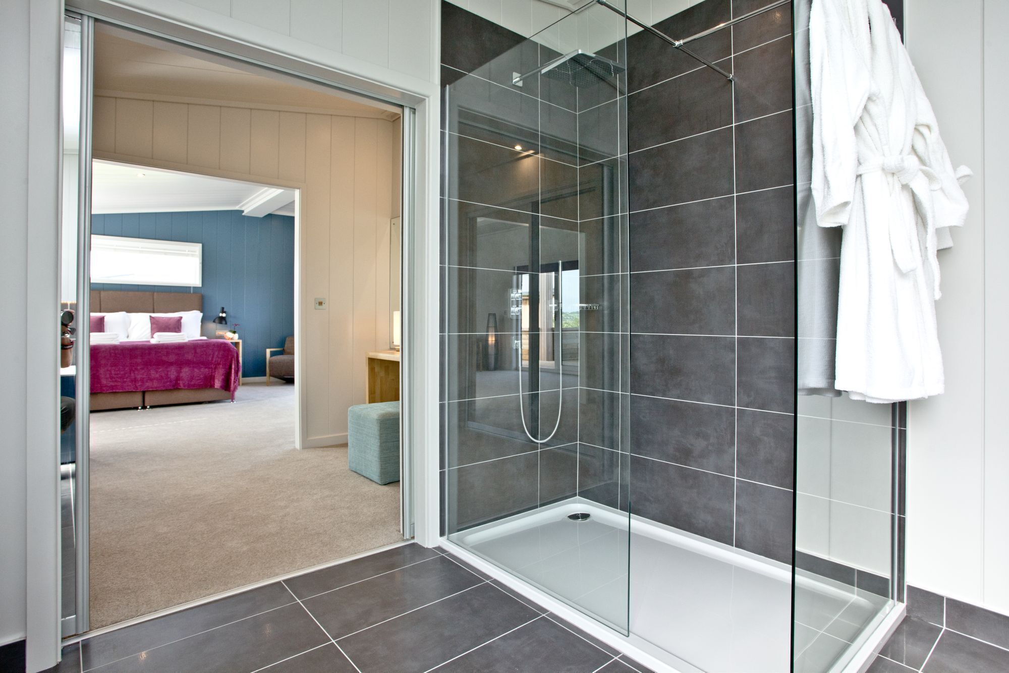 Bathtub, hair dryer, bathrobes, towels