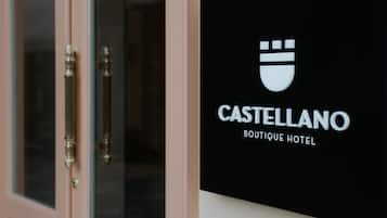 A sign for Castellano Boutique Hotel with a minimalist design and a logo.