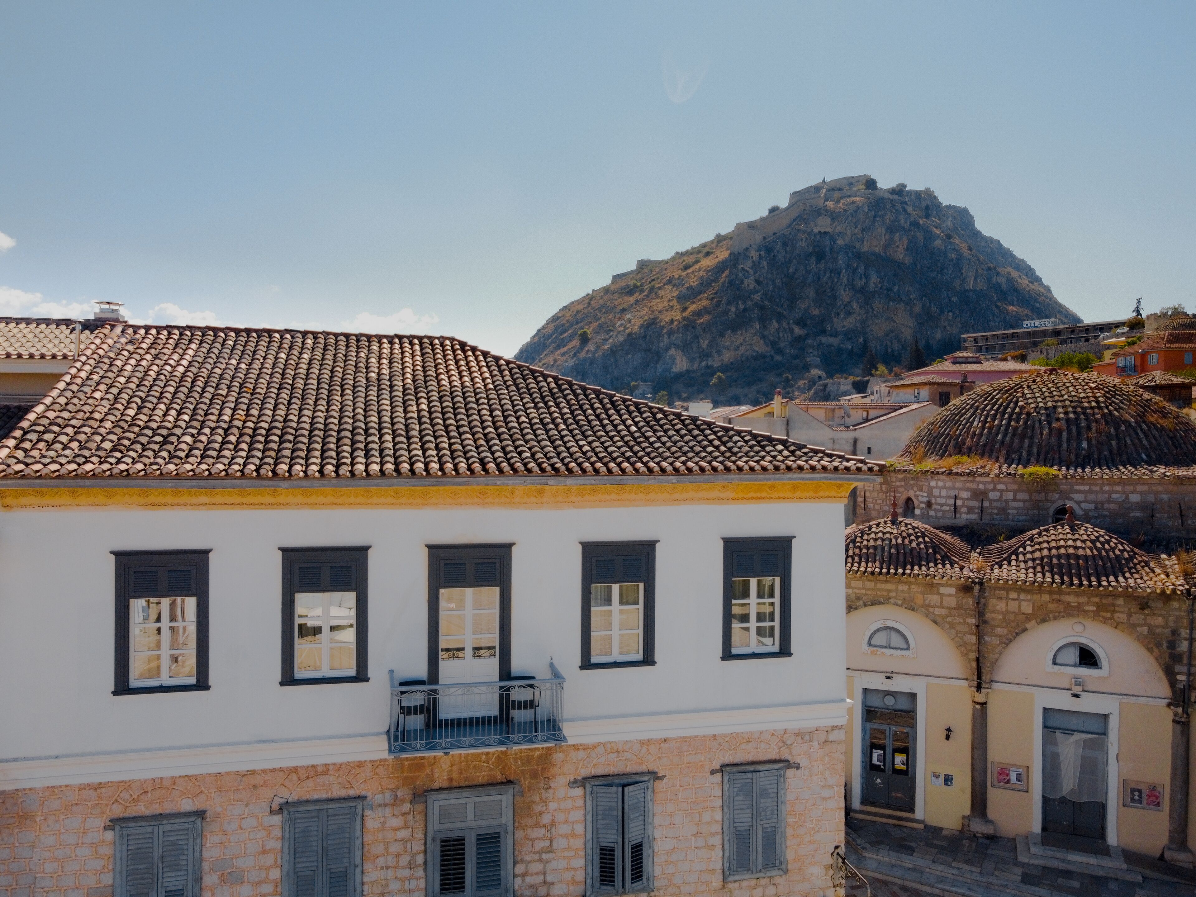A building with a tiled roof and a balcony.